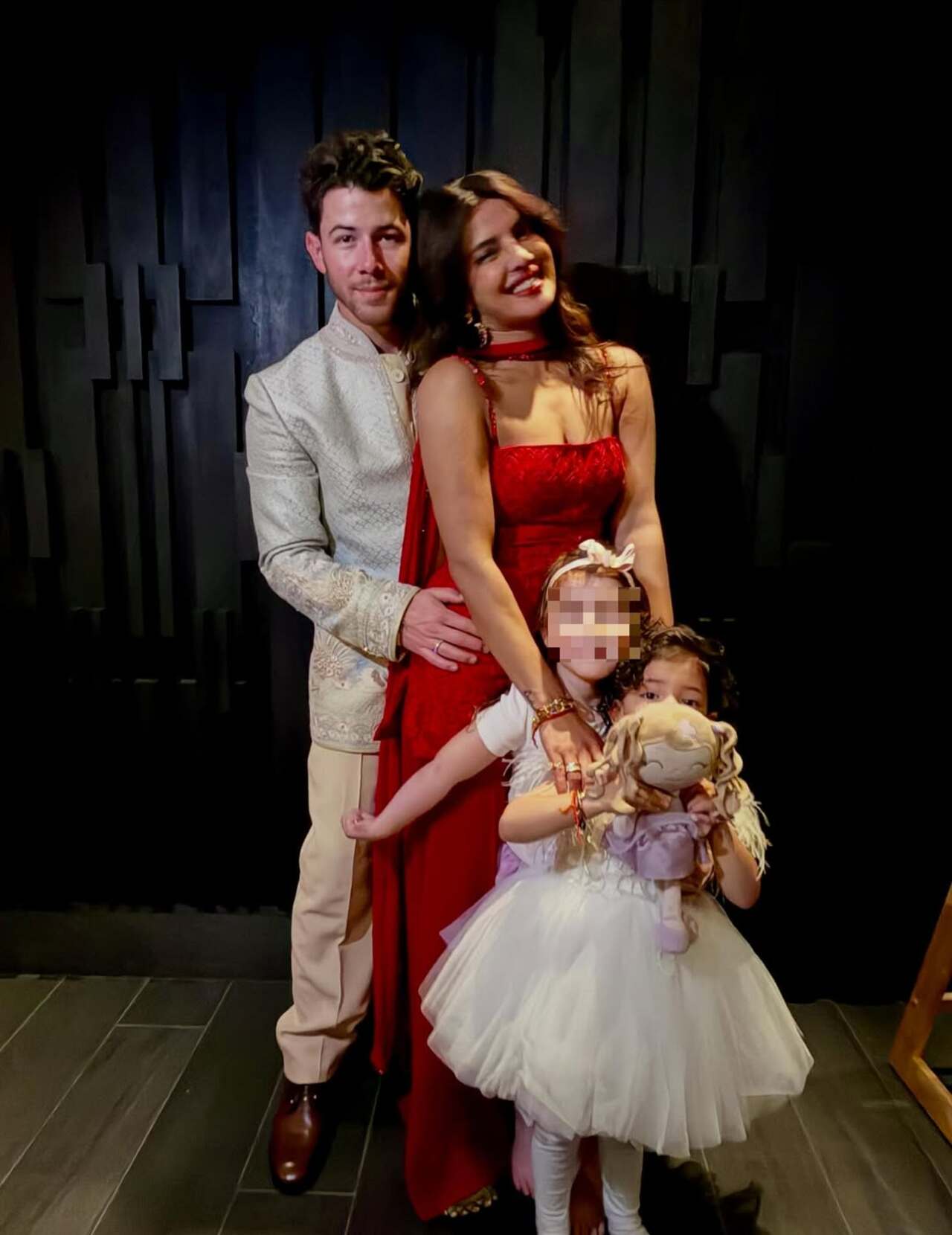 The family altogether: Priyanka Chopra and Nick Jonas pose with their little angel